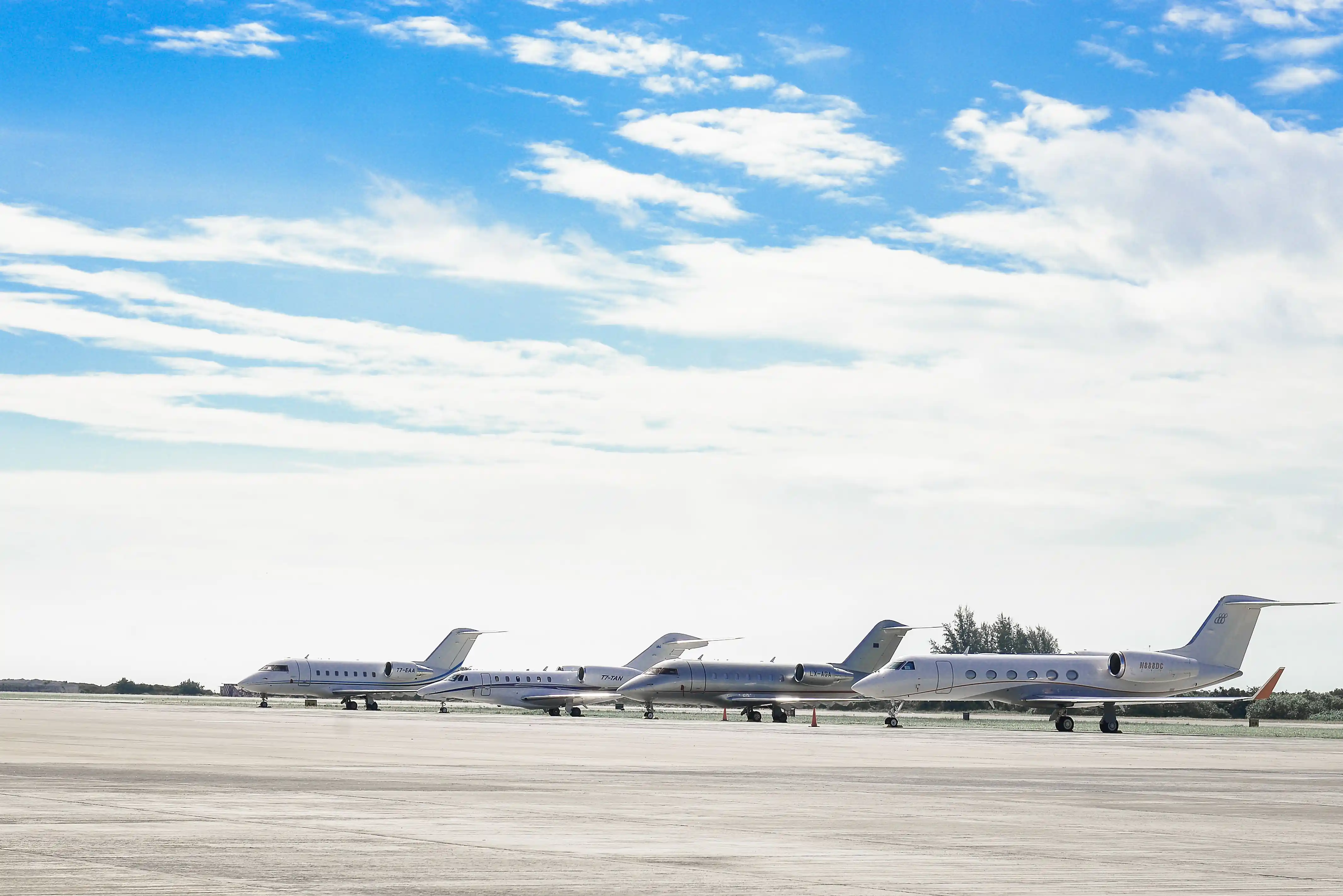 Business jets lined up on a Florida ramp, where our disinsection providers treat aircraft before boarding at Miami-Opa Locka Executive Airport (OPF)
