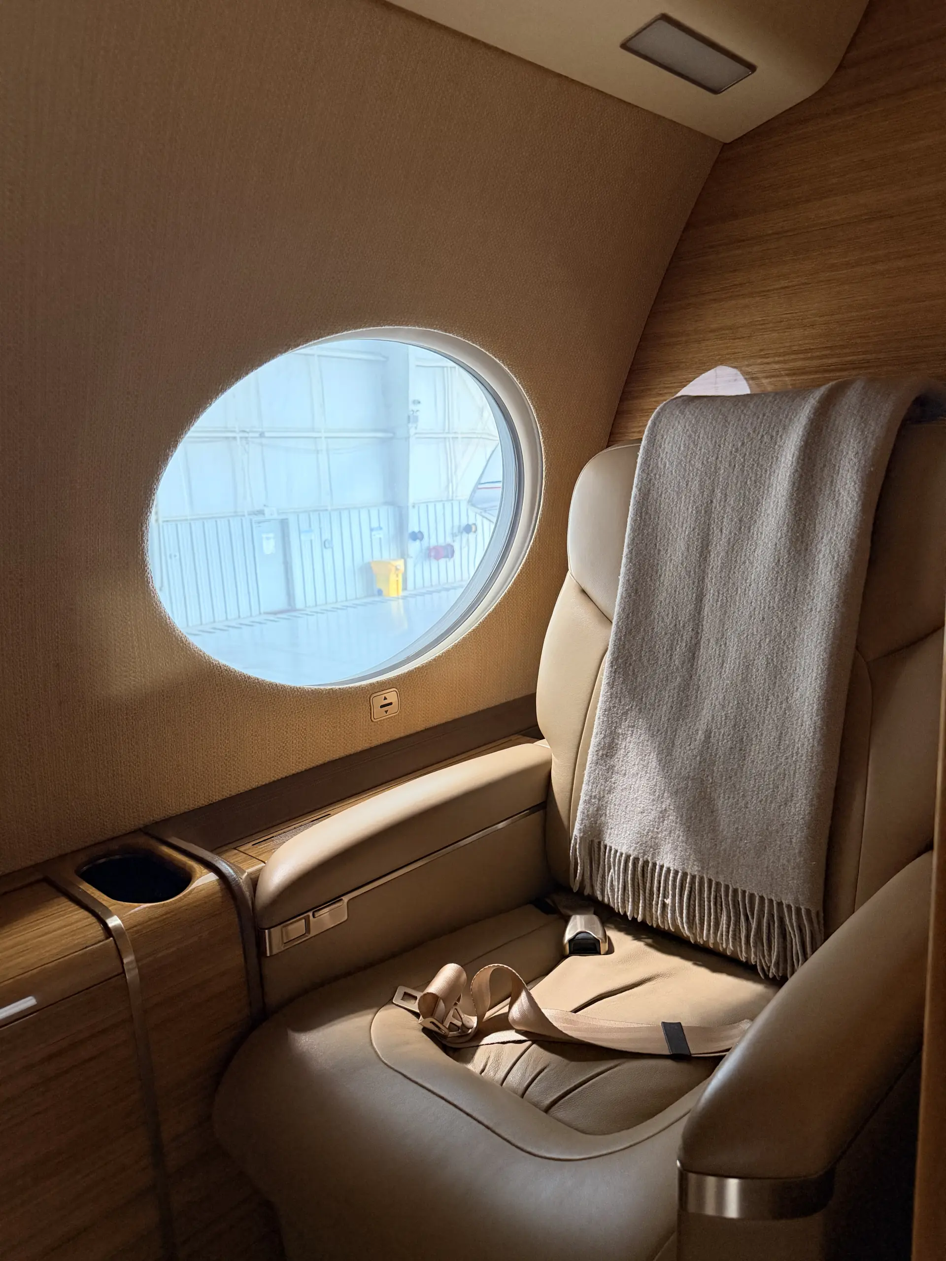 Gulfstream G650 cabin seat and window, empty before boarding, ready for pre-embarkation aircraft disinsection at Dallas Love Field (DAL), Texas