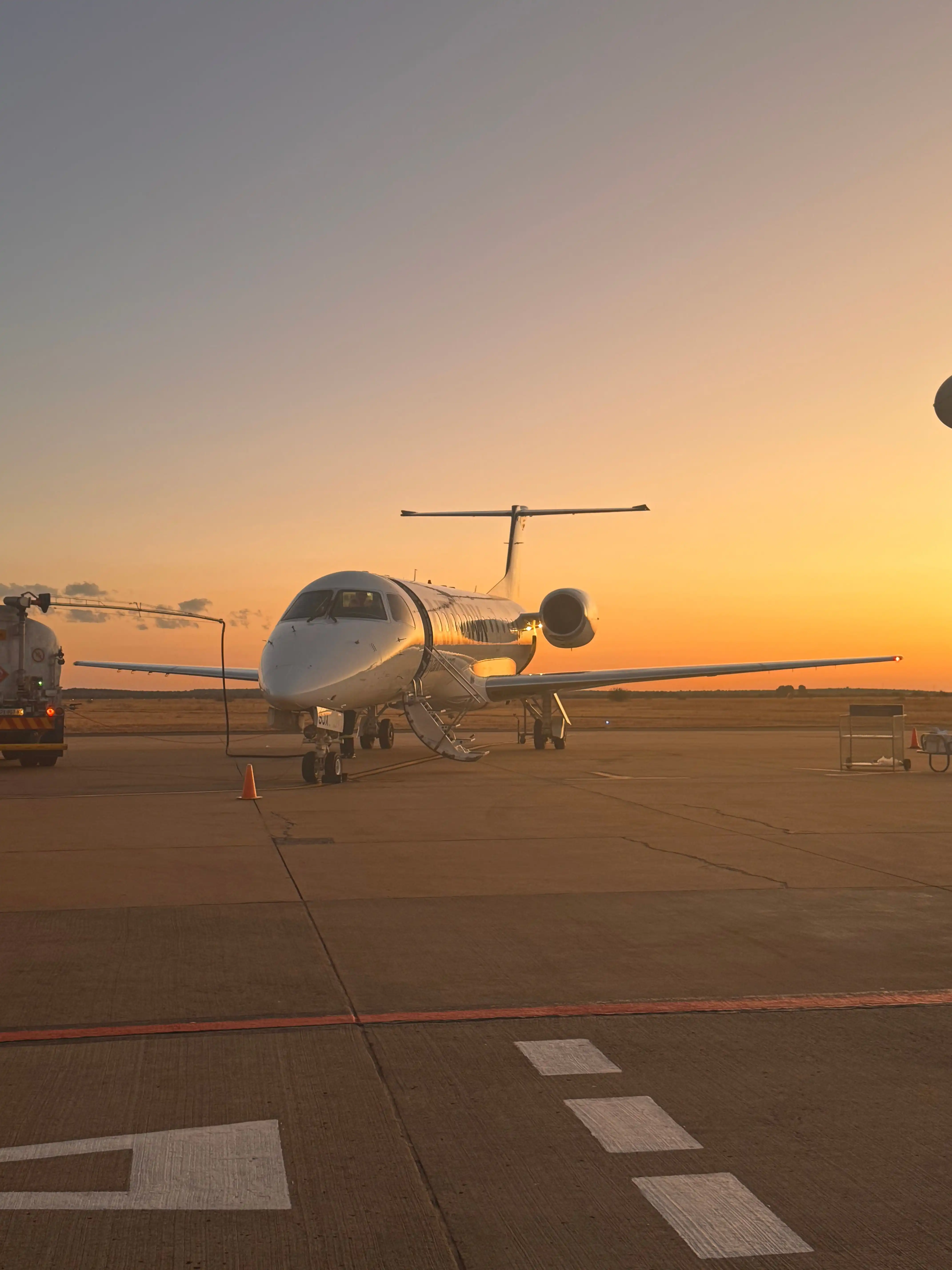 Embraer regional jet on the ramp at sunset before pre-embarkation disinsection at Miami International Airport (MIA), Florida