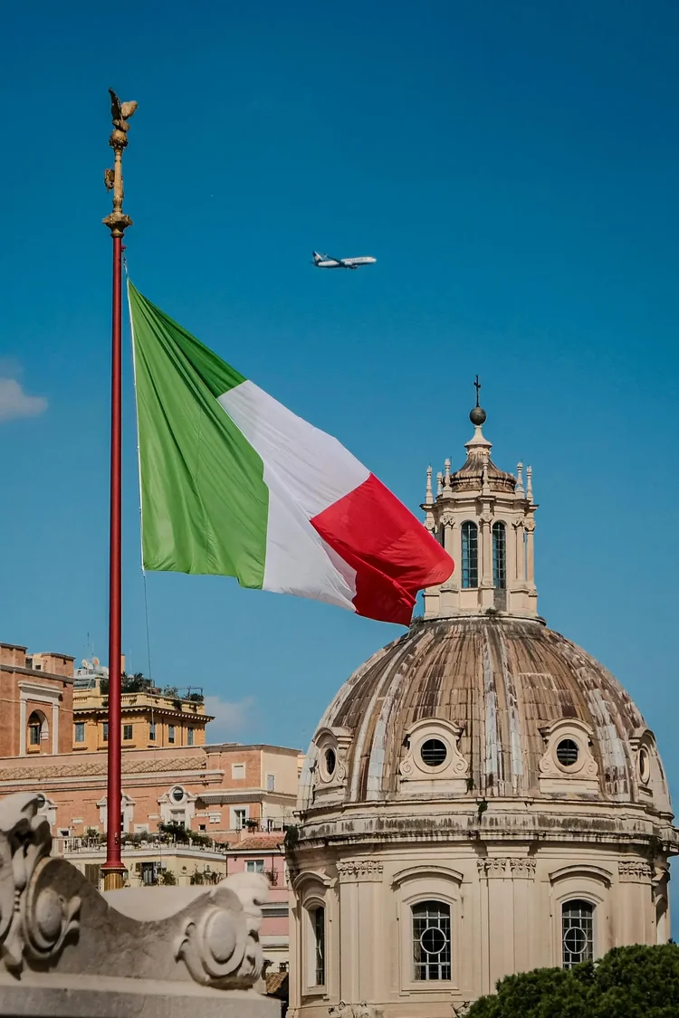 Italian flag over Rome, where aircraft arriving from the United States must be disinsected